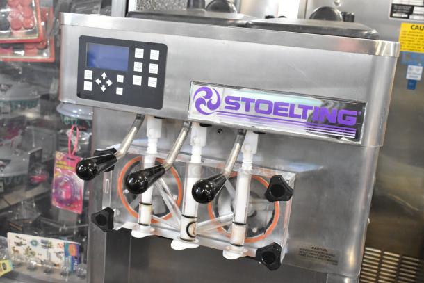 Stoelting F231-18I2YGAD1 commercial soft serve ice cream machine, stainless steel, two-flavor with twist, on casters.