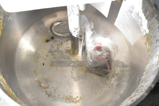 Estella 348SM80 Spiral Dough Mixer with metal bowl, dough hook, and bowl guard. Metal shows wear and mixing residue.