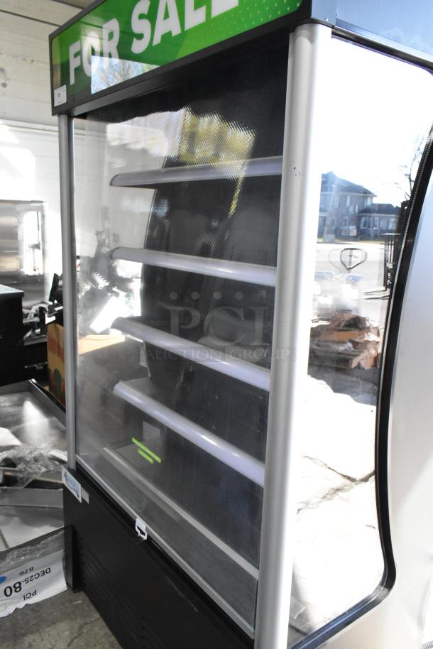 Brand new Avantco 189BVAC46HC 46" black refrigerated air curtain merchandiser on casters, 115V, visible "For Sale" sign.