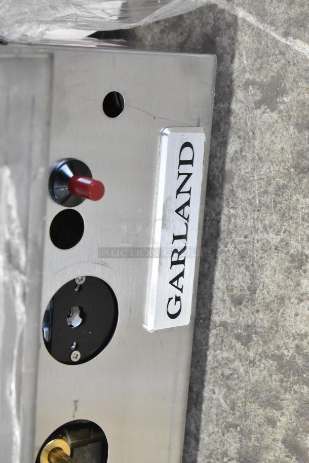 Garland 372GT72GT72N stainless steel griddle, new, with thermostatic controls and minor scratches. 168,000 BTU output.