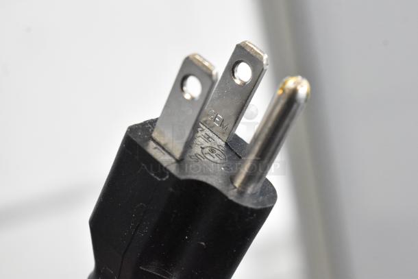 A close-up of a three-prong electrical plug, marked "GEM" suitable for use with the Avantco 178UBB72HC refrigerator.