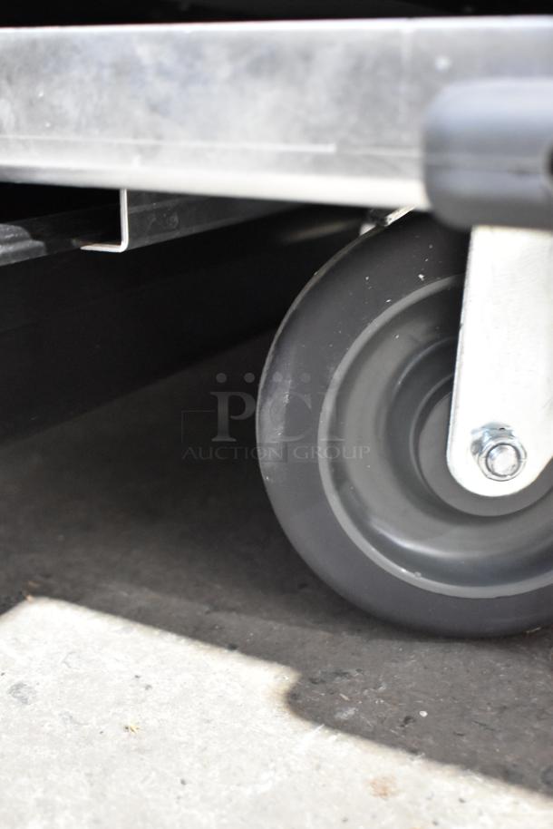 Commercial caster wheel of a 2025 Avantco Model 177HEAT1836I heated holding cabinet, metal frame visible.