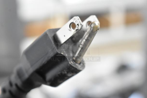 Close-up of a power plug. The auction item, Avantco 178CBE36HC chef base, is plug-in ready, showcasing its electric compatibility.