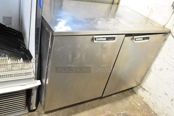 Delfield UC4148 stainless steel 2-door undercounter freezer on casters. Features Delfield logo, 115 volts, 1 phase.