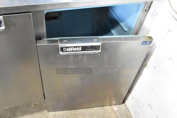 Delfield UC4148 stainless steel 2-door undercounter freezer with open door, on commercial casters, 115V, 1 Phase.