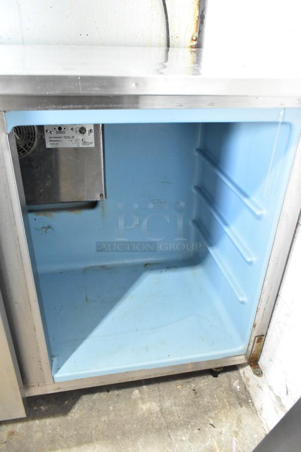 Delfield UC4148 stainless steel 2-door undercounter freezer on casters, 115V, interior view, slight wear visible.