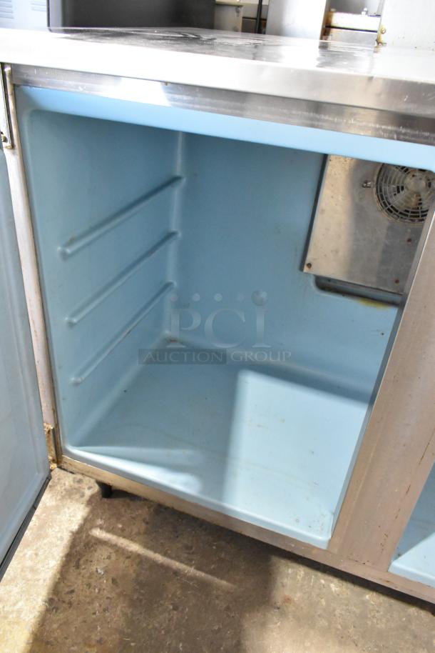 Delfield UC4148 stainless steel 2-door undercounter freezer; interior view; on casters; 115 volts, 1 phase.