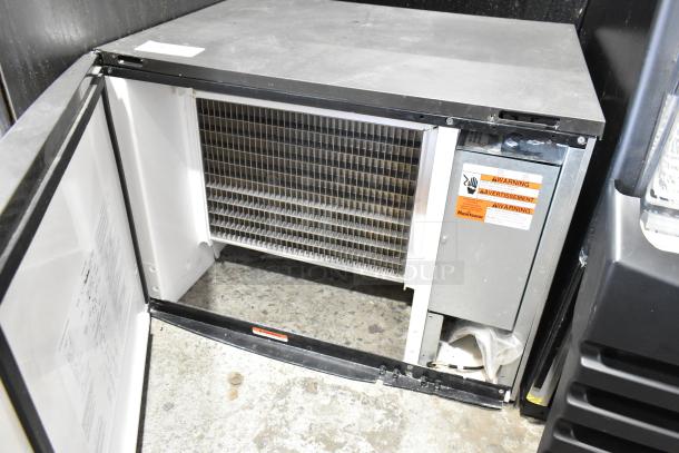 Manitowoc IY0606W-261D stainless steel commercial ice head, 208-230V, 1 phase, open panel view, warning labels visible.