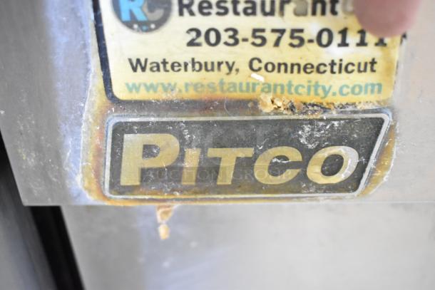 Pitco Frialator SG18 deep fat fryer label, showing brand name and manufacturer's contact info, on stainless steel surface.