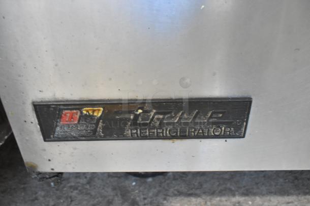 True TWT-27 undercounter cooler, stainless steel, commercial casters, single door, label shows model and brand name.