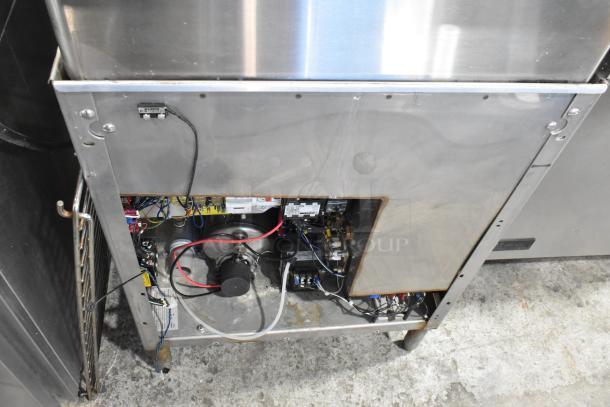 Champion stainless steel commercial corner pass-through dishwasher, 208-240 volts, 1 phase. Internal components visible.