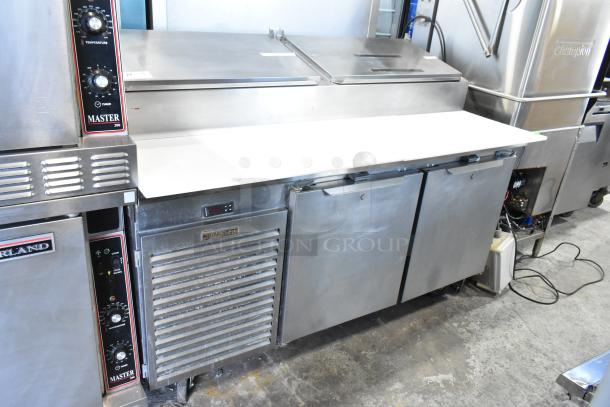 Traulsen TS066HT stainless steel prep table, commercial casters, model label visible, 115 volts, 1 phase, good condition.