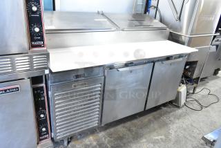 Traulsen TS066HT stainless steel prep table, commercial casters, model label visible, 115 volts, 1 phase, good condition.