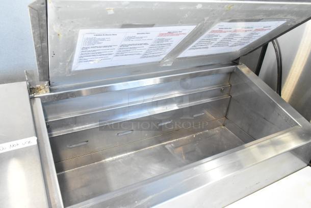 Traulsen TS066HT stainless steel prep table, commercial casters, 115V, open lid showing interior and inserted documents.
