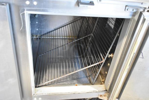 Traulsen TS066HT stainless steel prep table interior with wire shelving, commercial casters, 115V, 1 phase, used condition.