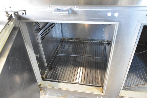 Traulsen TS066HT stainless steel commercial prep table interior with wire shelf, showing clean condition and sturdy build.