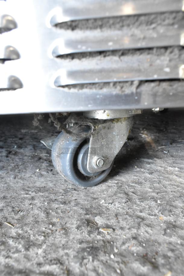 Close-up of a rotating caster on a stainless steel Garland Master 200 convection oven, showing signs of wear.