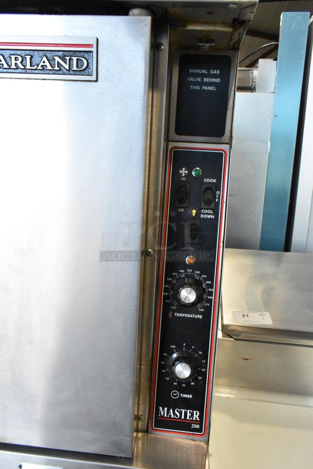Garland Master 200 stainless steel convection oven, solid doors, metal racks, thermostatic controls, GAS valve marked.