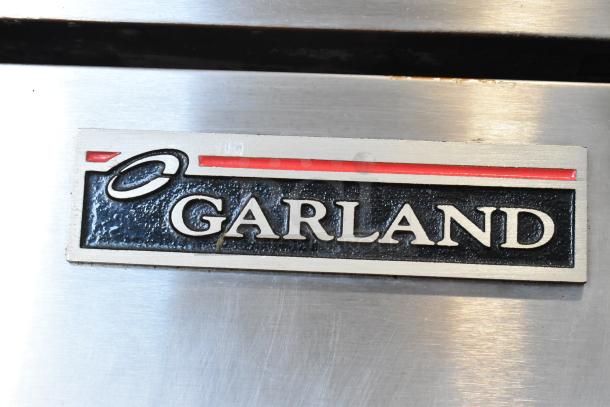 Garland Master 200 Stainless Steel Convection Oven, solid doors, metal racks, thermostatic controls, commercial use.