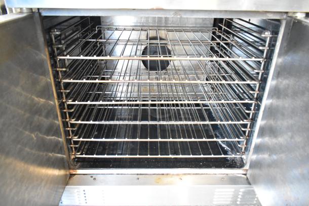 Stainless steel Garland Master 200 convection oven interior with metal racks, thermostatic controls, and solid doors.