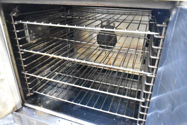 Garland Master 200 convection oven interior, showing multiple metal racks. Solid doors, thermostatic controls, on casters.