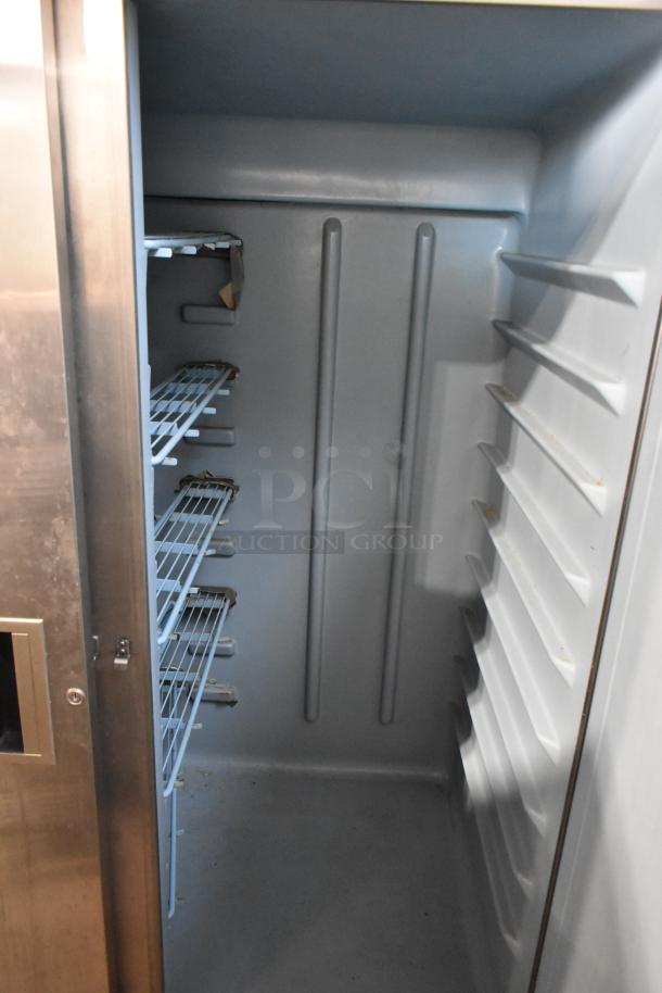 Delfield Stainless Steel Commercial 2 Door Reach-In Cooler, left door locked, 115 volts, 1 phase, interior shelving visible.