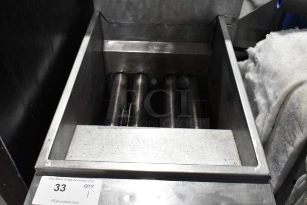 Mainstreet stainless steel commercial deep fat fryer, floor style, showing interior heating elements. Clean, with some signs of use.