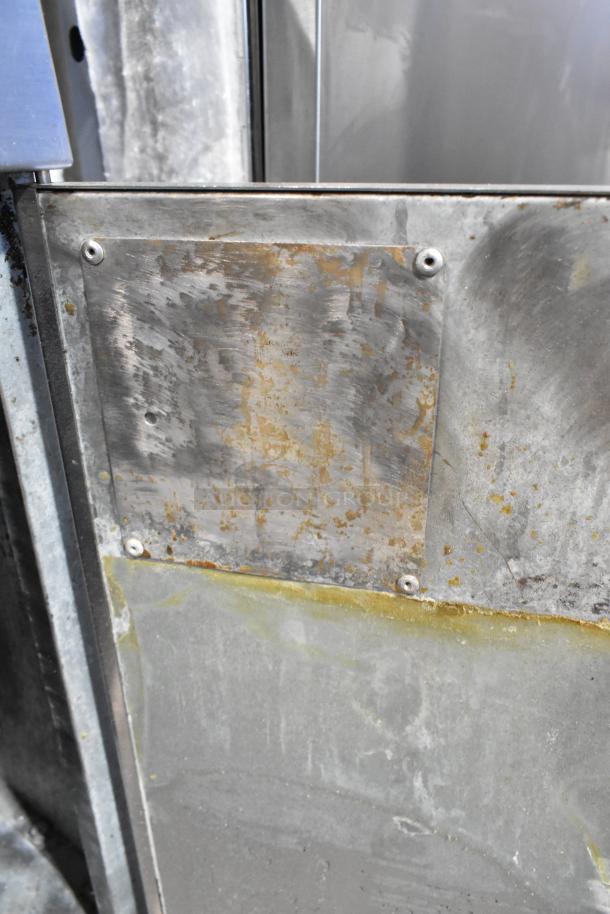 Mainstreet Stainless Steel Commercial Floor Style Deep Fat Fryer, visible wear, metal surface, and mounting screws.