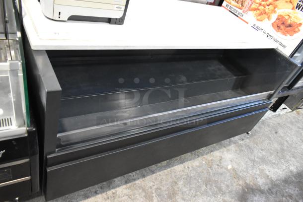 Metal commercial floor style horizontal Grab N Go merchandiser, black finish, spacious interior, used condition.