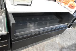 Metal commercial floor style horizontal Grab N Go merchandiser, black finish, spacious interior, used condition.