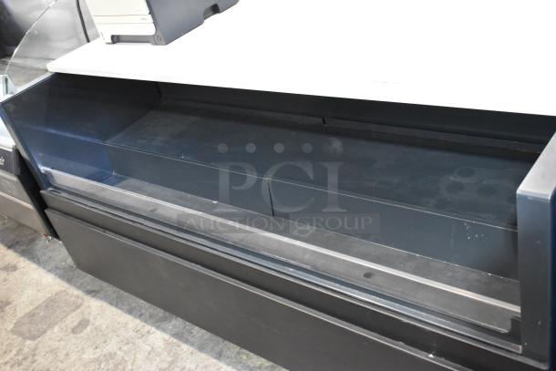 Metal commercial floor style horizontal grab-n-go merchandiser in used condition, featuring a black finish and sturdy construction for convenient product display.