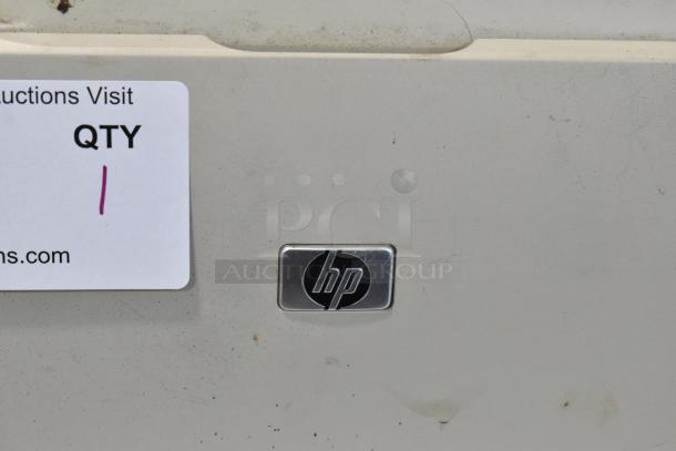 HP LaserJet P2055dn Countertop Printer. Visible HP logo. Condition shows signs of use. Auction tag indicating quantity 1.