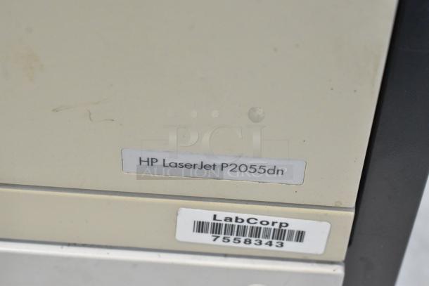 HP LaserJet P2055dn printer with visible label, used condition, includes LabCorp inventory tag, model details on front.