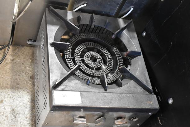 Stainless steel commercial countertop gas single burner stock pot range, sturdy cast iron grate, control knobs visible.