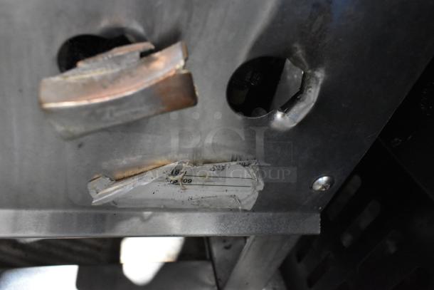 Stainless steel commercial gas-powered single burner with control knob; visible worn label; ideal for stock pot cooking.