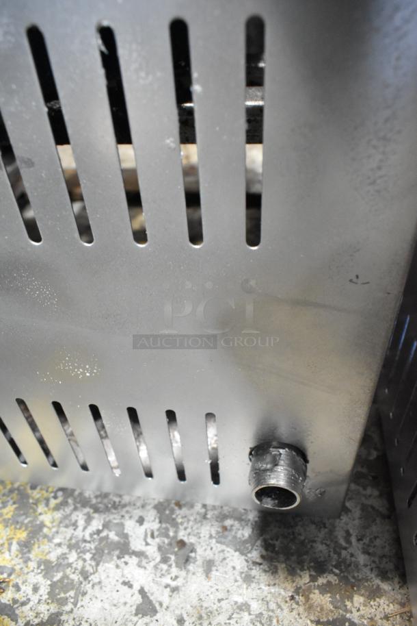 Stainless steel single burner stock pot range, gas-powered, countertop design, vented panel, used condition.