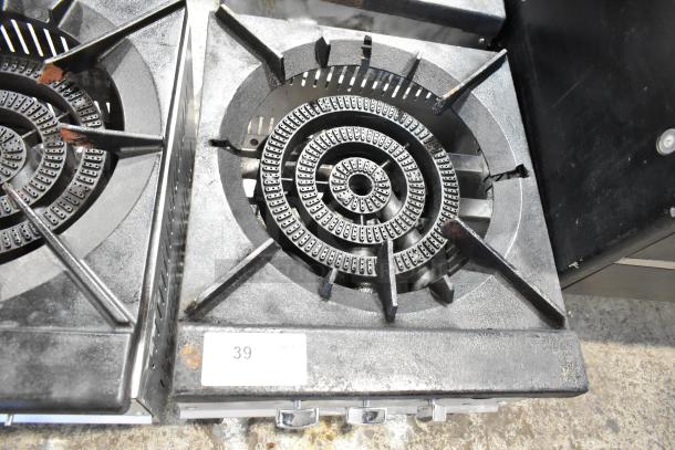 Stainless steel commercial countertop gas burner with a single stock pot range. Features a sturdy cast iron grate. Visible wear and a numbered tag "39".