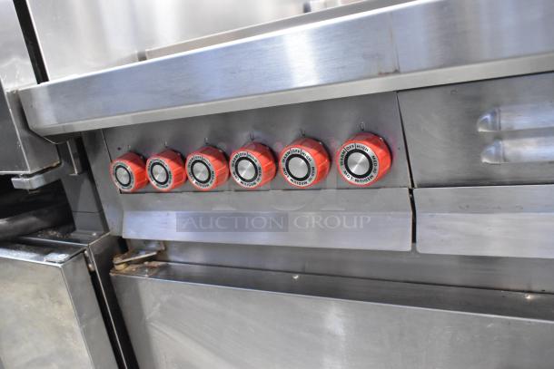 Lang RTI36E stainless steel electric range with 6 burners and oven, 208-240V, 3 phase. Red control knobs visible.