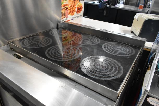 Lang RTI36E stainless steel commercial electric 6 burner range with oven. 208-240V, 3 phase, in good condition.