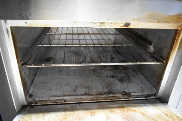 Lang RTI36E stainless steel commercial electric 6 burner range with oven, showing used interior. 208-240 volts, 3 phase.