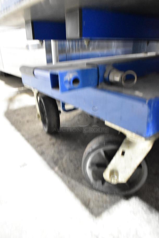 Upright UL25 068001-000 metal vertical lift mast base, featuring sturdy wheels, in good condition.