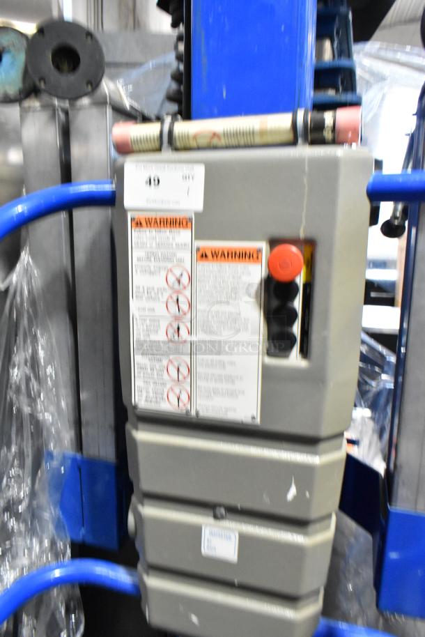 Upright UL25 068001-000 metal vertical lift mast with control panel, warning labels, and blue support arms.