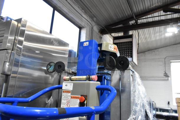 Upright UL25 068001-000 Metal Vertical Lift Mast, blue and gray, with safety labels and controls, in used condition.