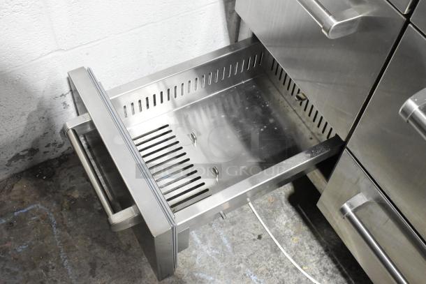 Sub Zero stainless steel commercial unit with two doors and four drawers, 115 volts, 1 phase, featuring durable construction.