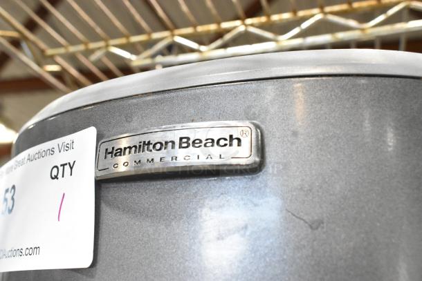 Hamilton Beach HMD400 metal commercial 3-head drink blender, 120 volts, with logo plate and auction tag visible.
