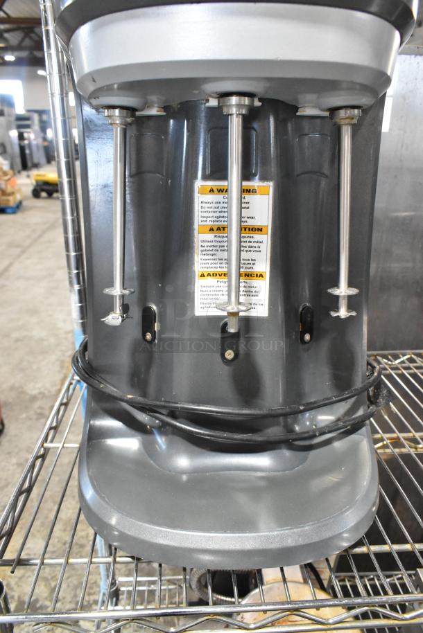Hamilton Beach HMD400 commercial blender with 3 heads, metallic finish, visible warning label, 120 volts, 1 phase.
