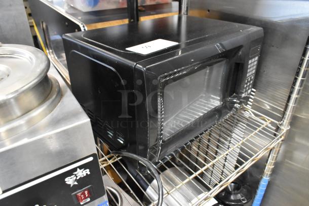 Farberware EM720CGA-B countertop microwave oven with plate, black finish, 120 volts, 1 phase. Appears in good condition.