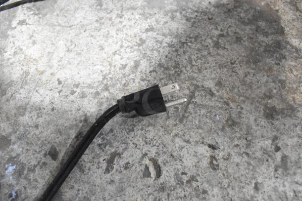 Blendtec ES3 Blender power cord, standard 120V plug, shown on a concrete surface. Plug in good condition.