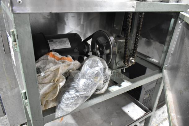 Lenin MQ077 metal tortilla machine, commercial floor style, on casters. 110V, 1 Phase. Interior motor and chain visible.