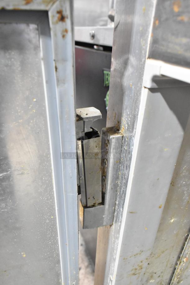 Continental 1R-HD stainless steel cooler hinge close-up, showing signs of wear. Commercial casters and 115V, 1 phase power.